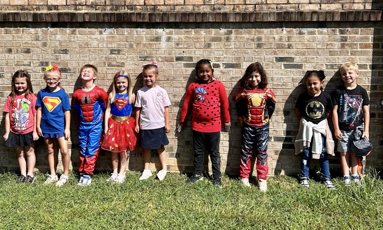 class dressed as superheroes