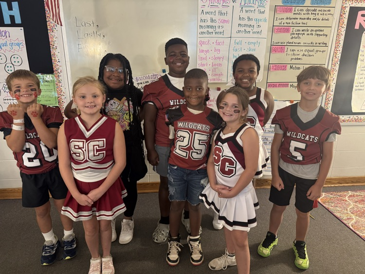 elementary cheerleaders and football players