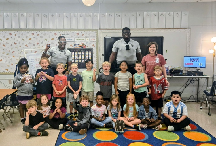 class stands with resource officers after earning the wildcat way in 