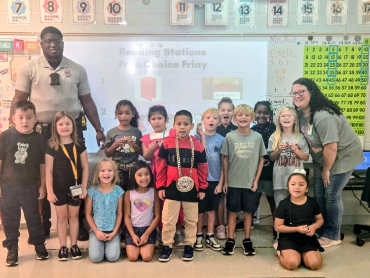 class stands with resource officers after earning the wildcat way in 