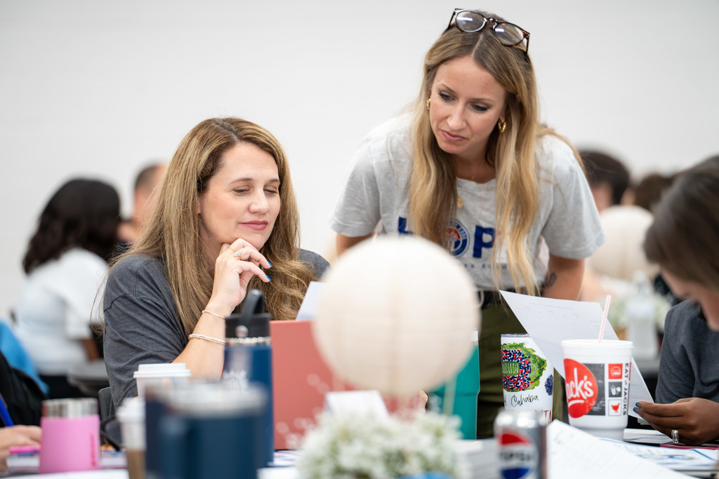 Leaders discuss at a table.