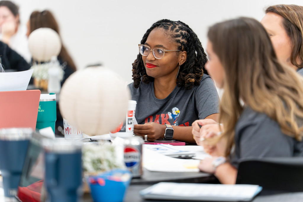 Leaders discuss at a table.