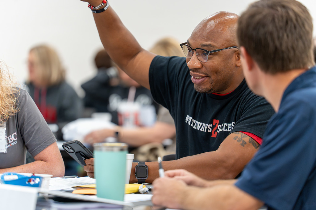 District leaders meet at a table.