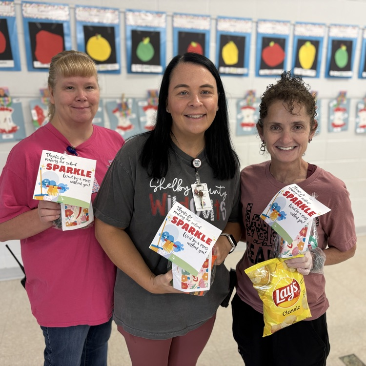 custodial team pictured with treats from admin 