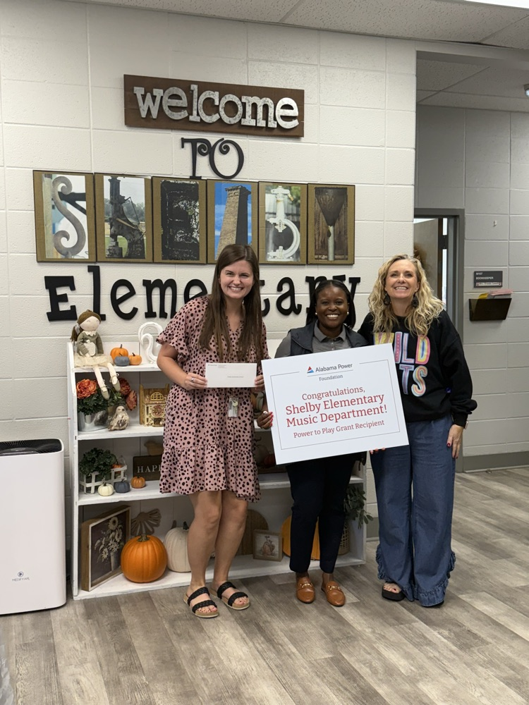 music teacher and principal accepting a grant 