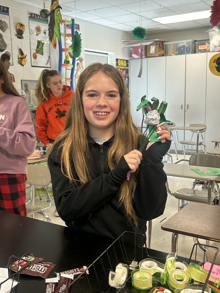 7th grade science students enjoying their Halloween activity with supplies in front of them