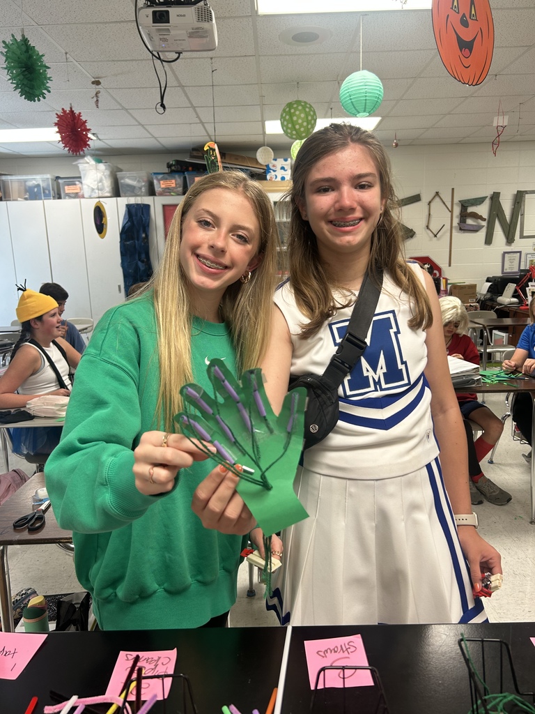 7th grade science students enjoying their Halloween activity with supplies in front of them