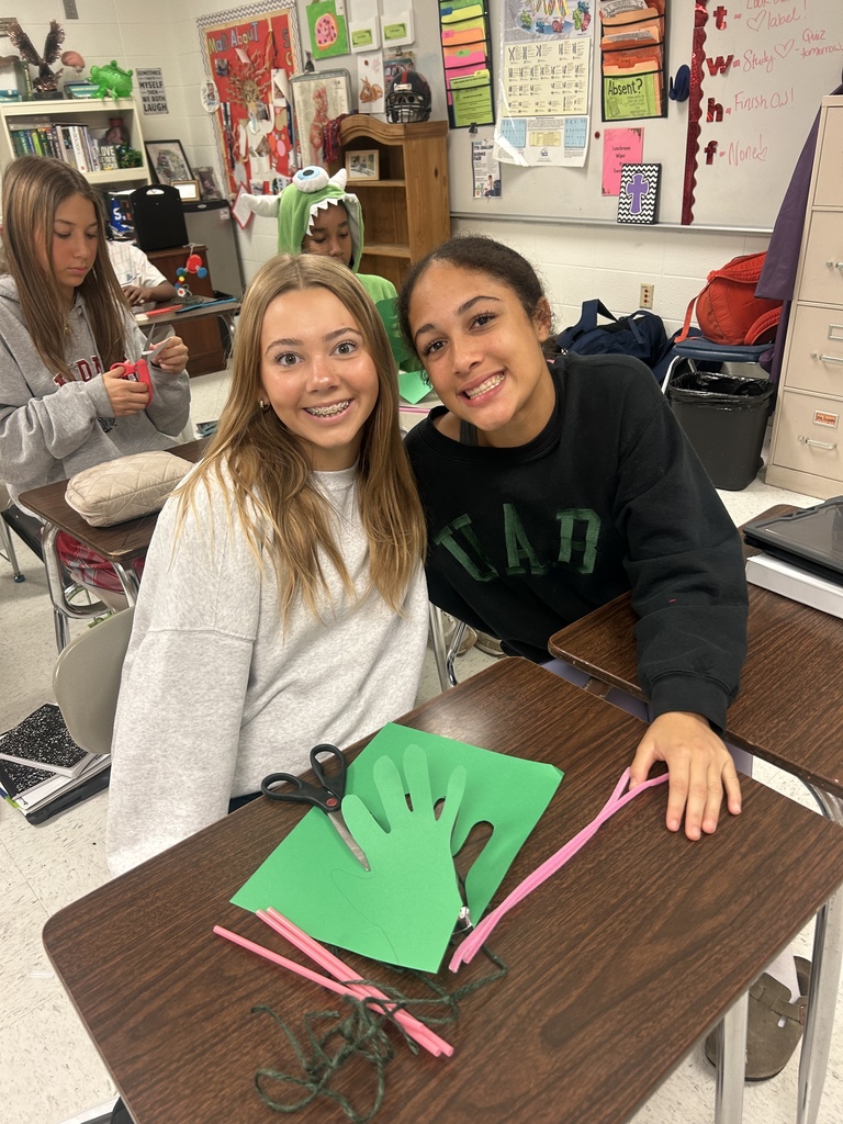 7th grade science students enjoying their Halloween activity with supplies in front of them