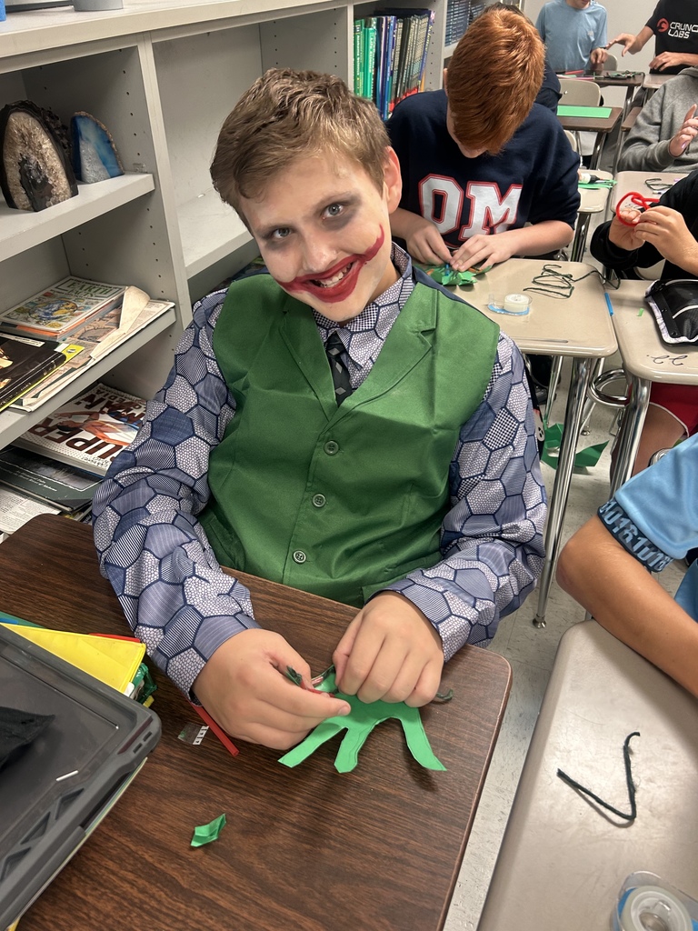 7th grade science students enjoying their Halloween activity with supplies in front of them
