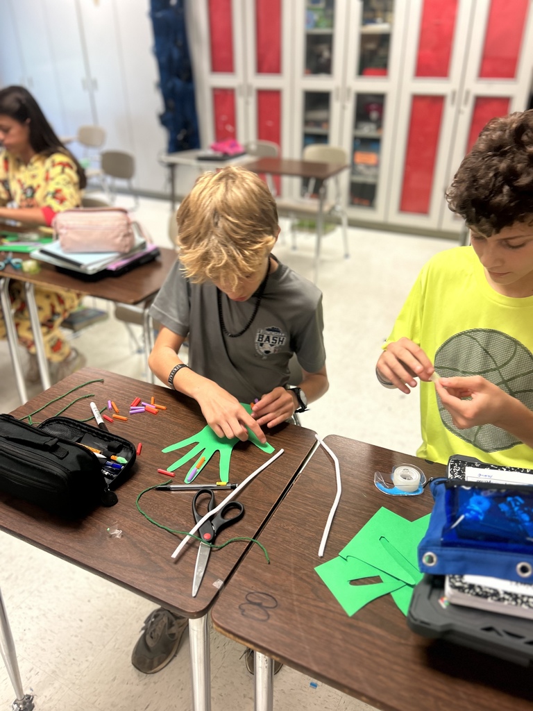 7th grade science students enjoying their Halloween activity with supplies in front of them