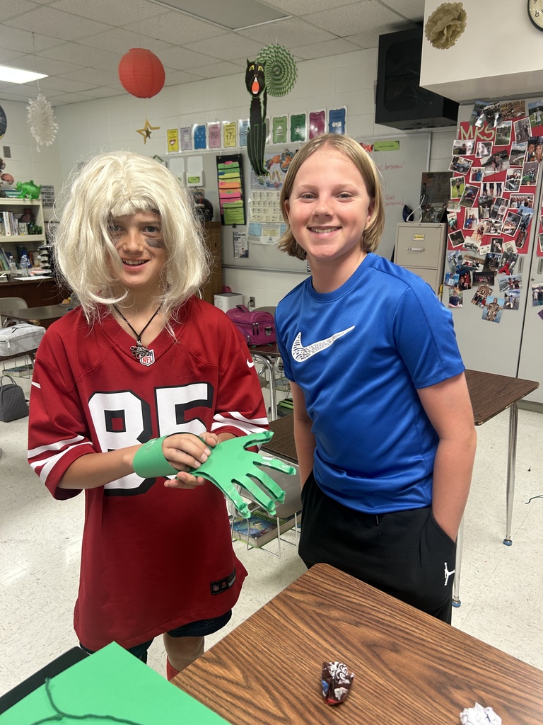 7th grade science students enjoying their Halloween activity with supplies in front of them