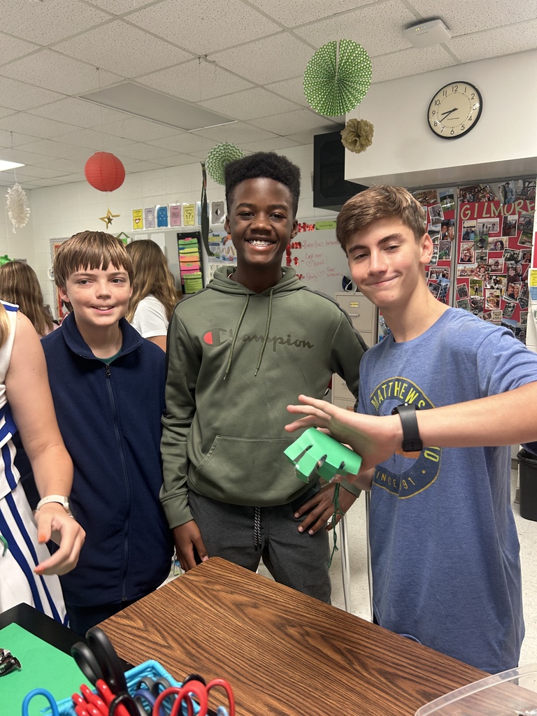 7th grade science students enjoying their Halloween activity with supplies in front of them