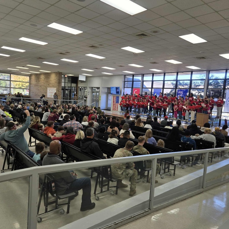 choir performing during the Veterans Day program as visitors look on