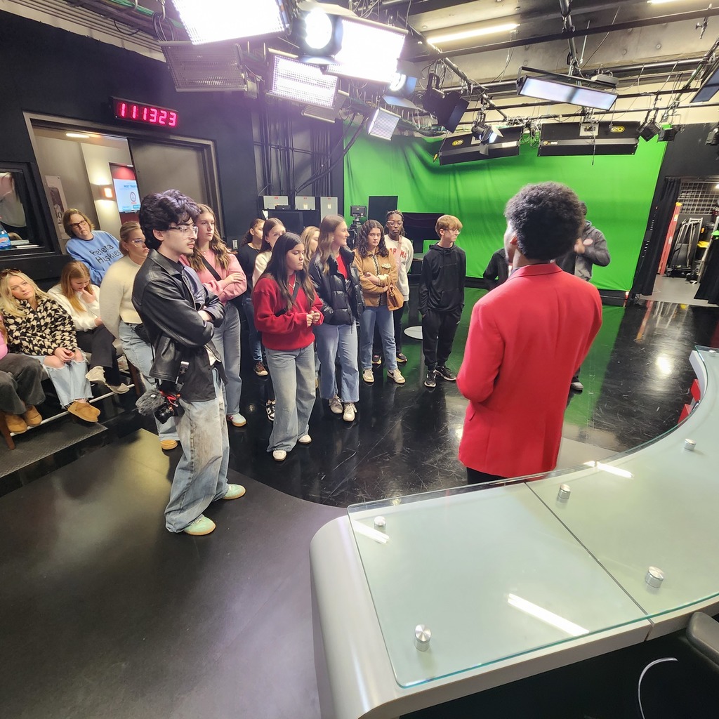 Students on a TV set listening to a presentation