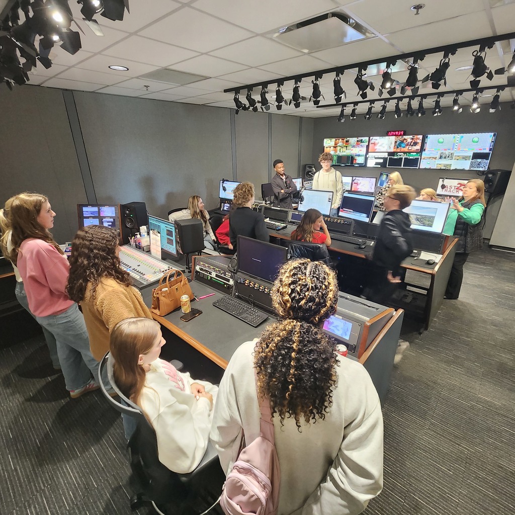 Students in a TV control room learning about TV news