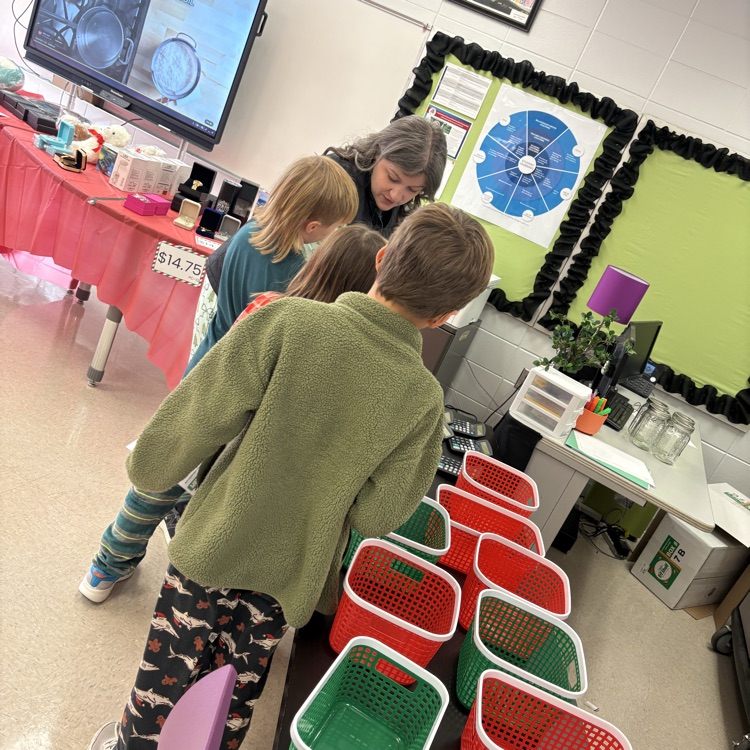 volunteer explains holiday shopping to students 