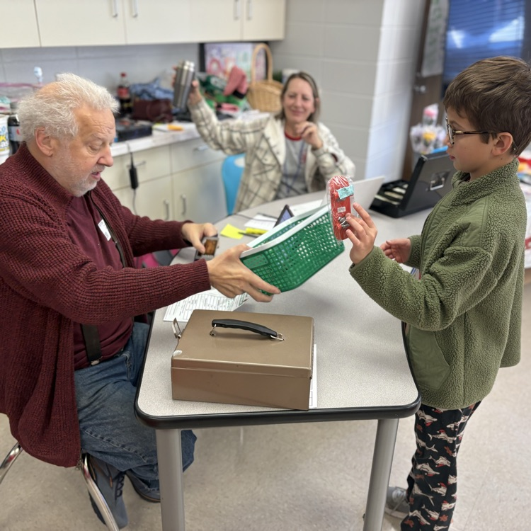 student pays for items at Holiday shop 