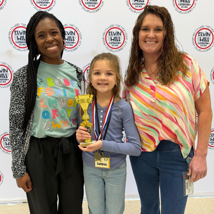 school administrators with the spelling bee winner 