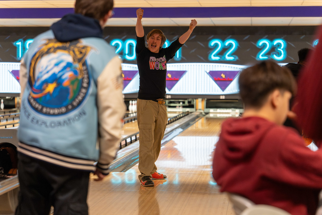 Student celebrates after bowling.