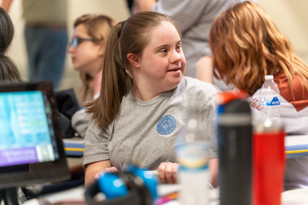 Student smiles at Special Needs bowling event.