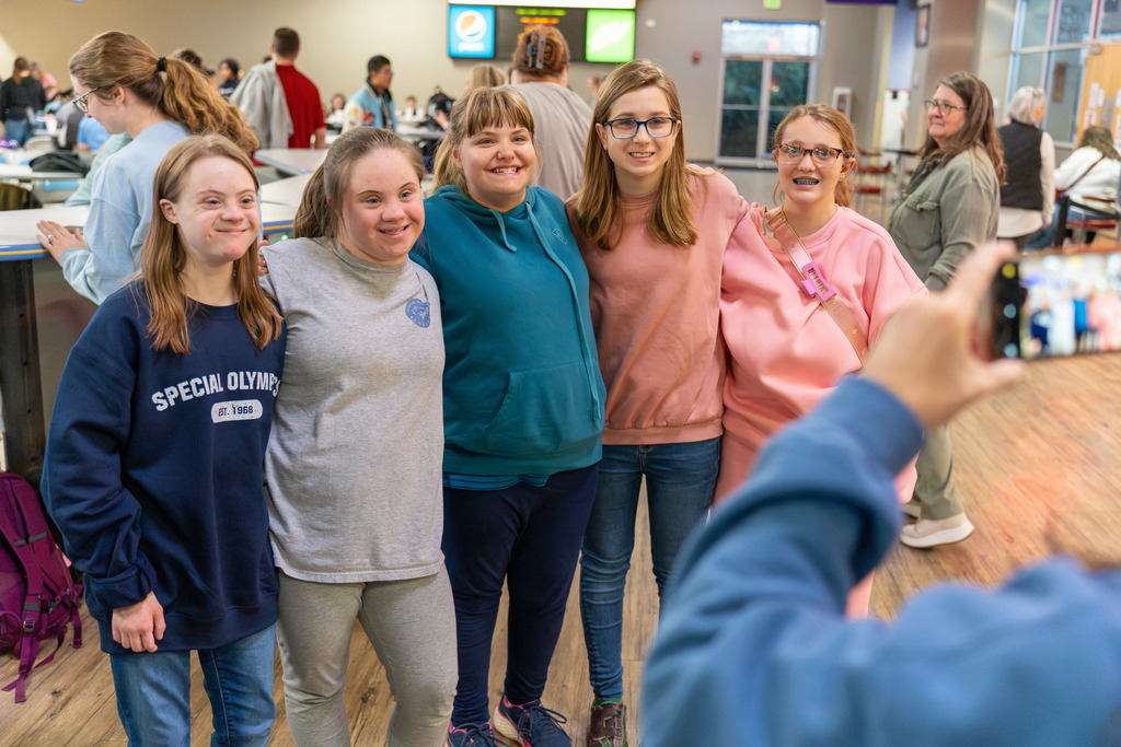 Group of students take a photo at Special Needs bowling event.