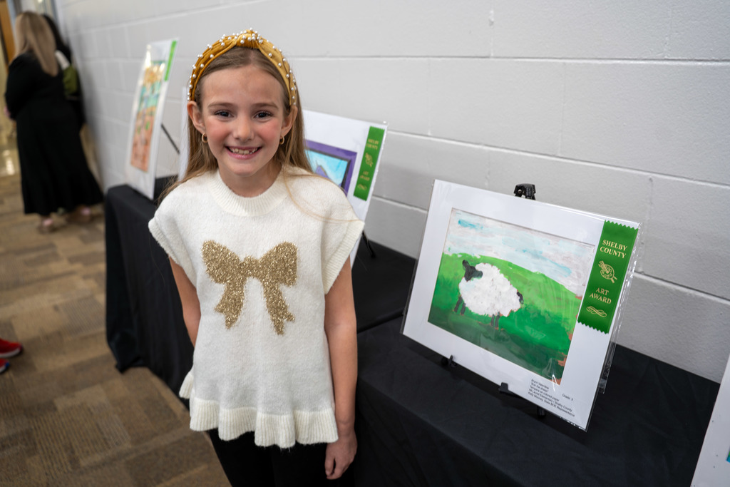 A student poses with art.