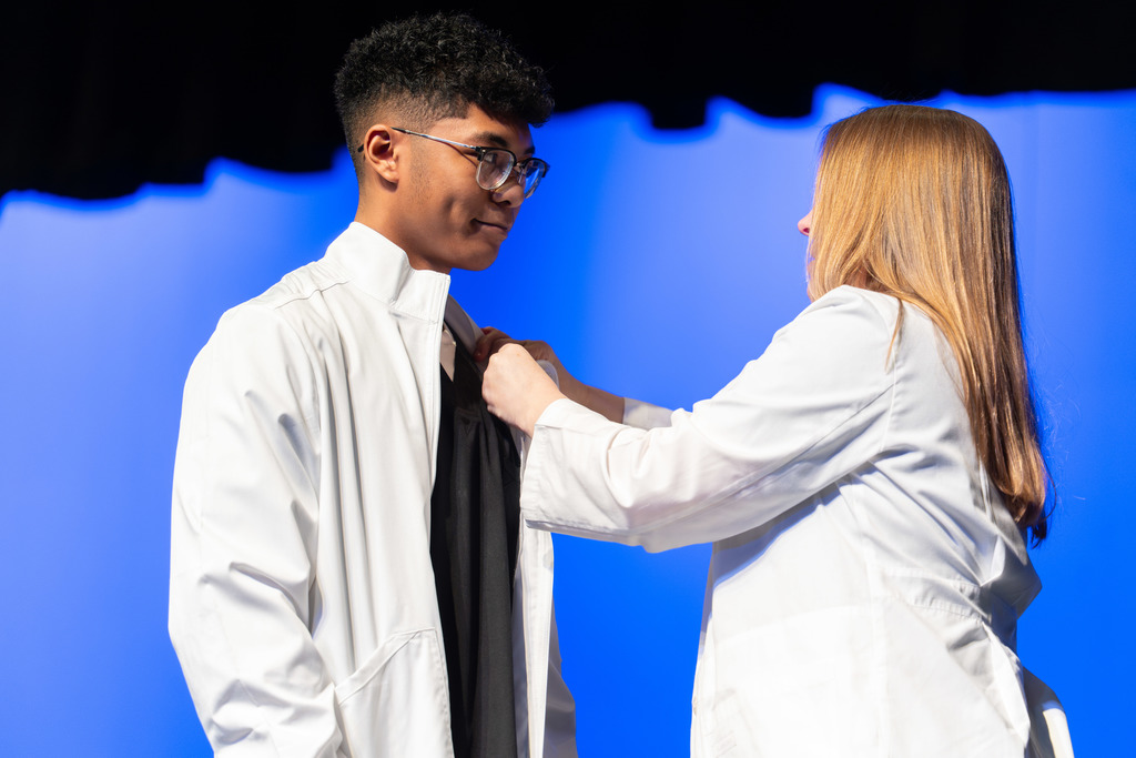 Student is pinned during the ceremony.
