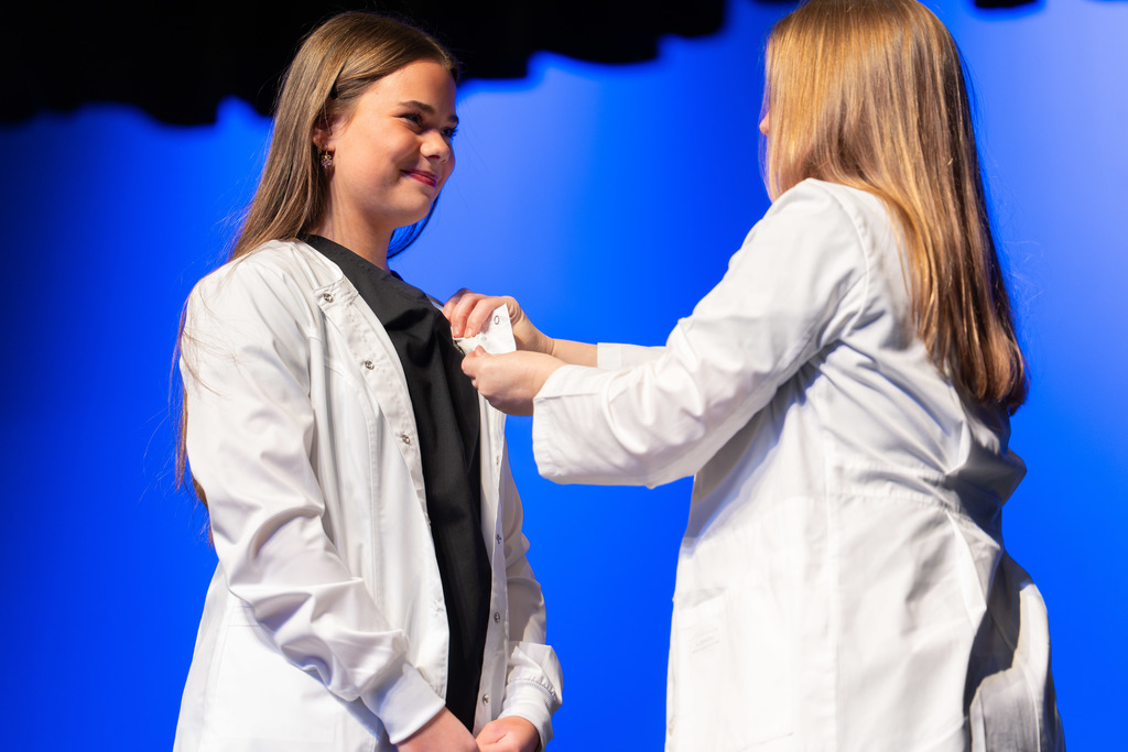 Student is pinned during the ceremony.