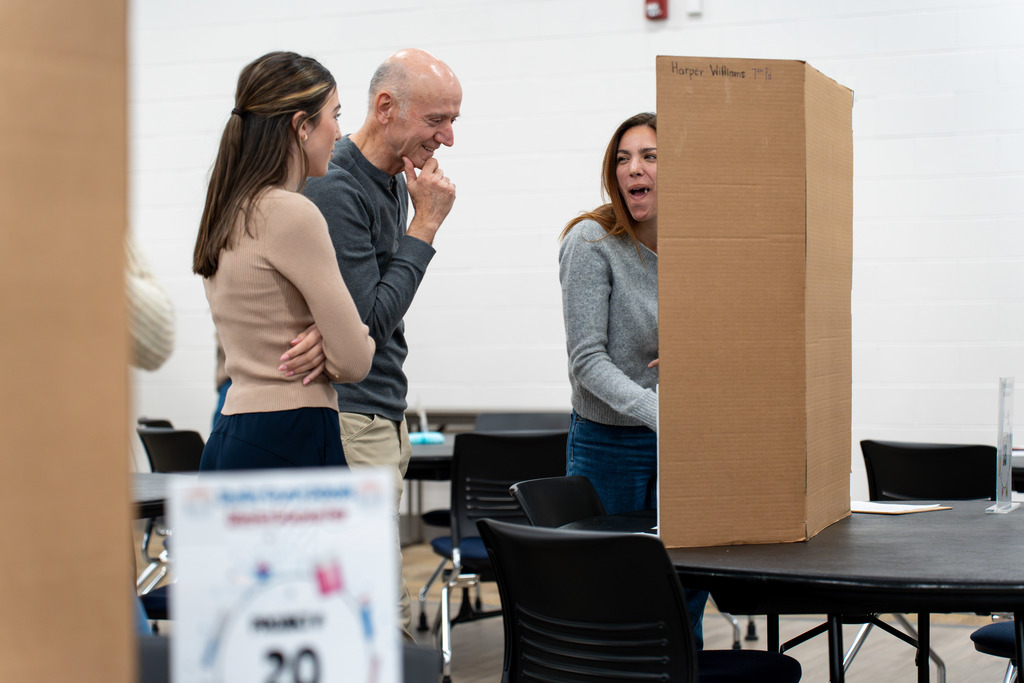 People browse the Science Fair projects.