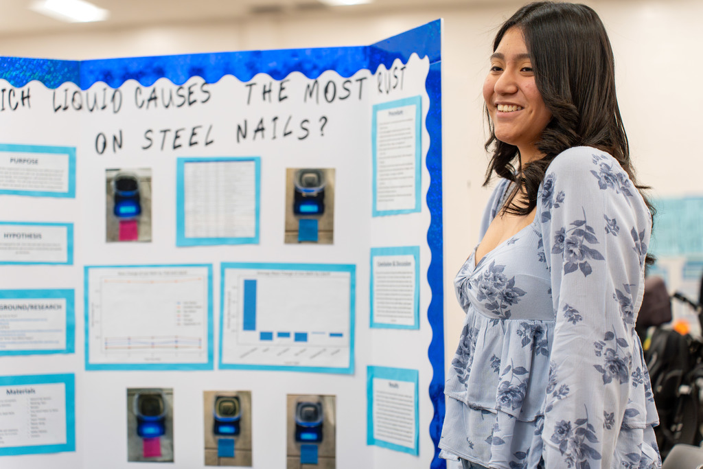 Student poses in front of their project.