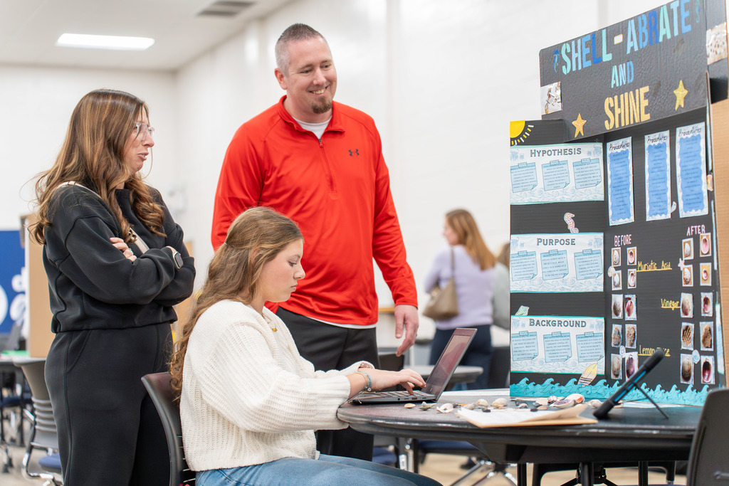 People browse the Science Fair projects.
