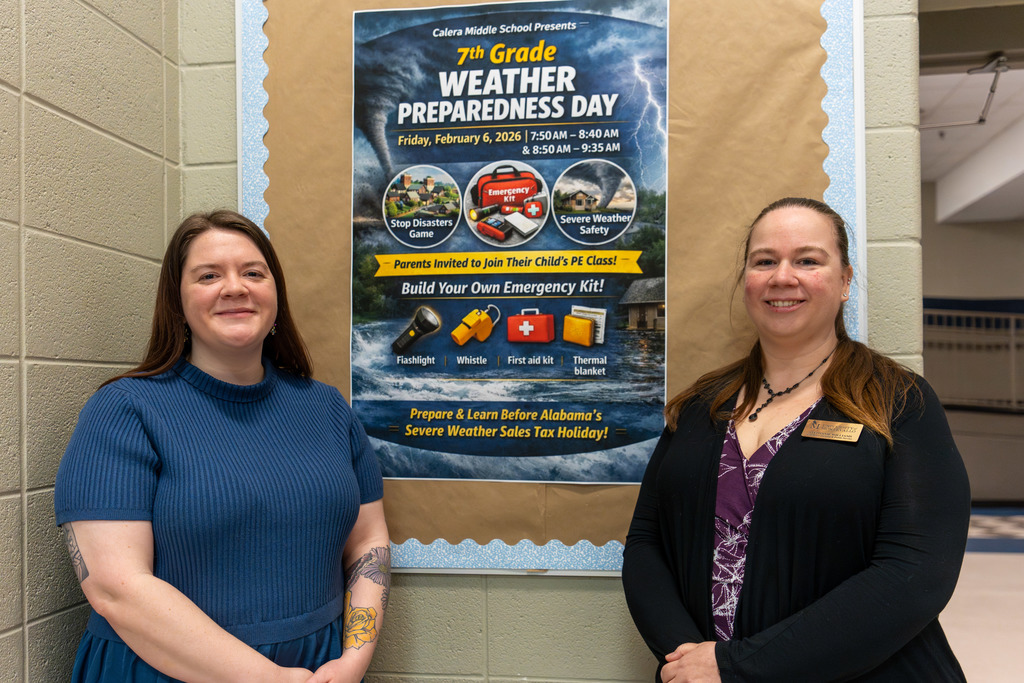 Teacher and sponsor with an event flyer.