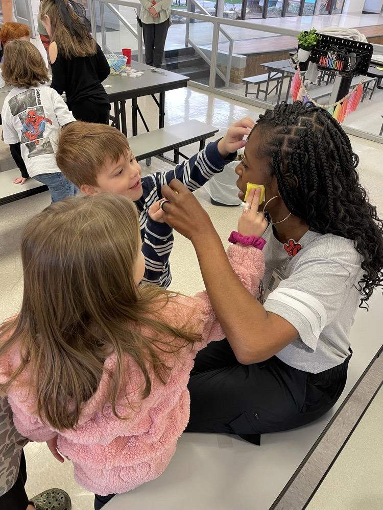 students apply temporary tattoos on administrators 