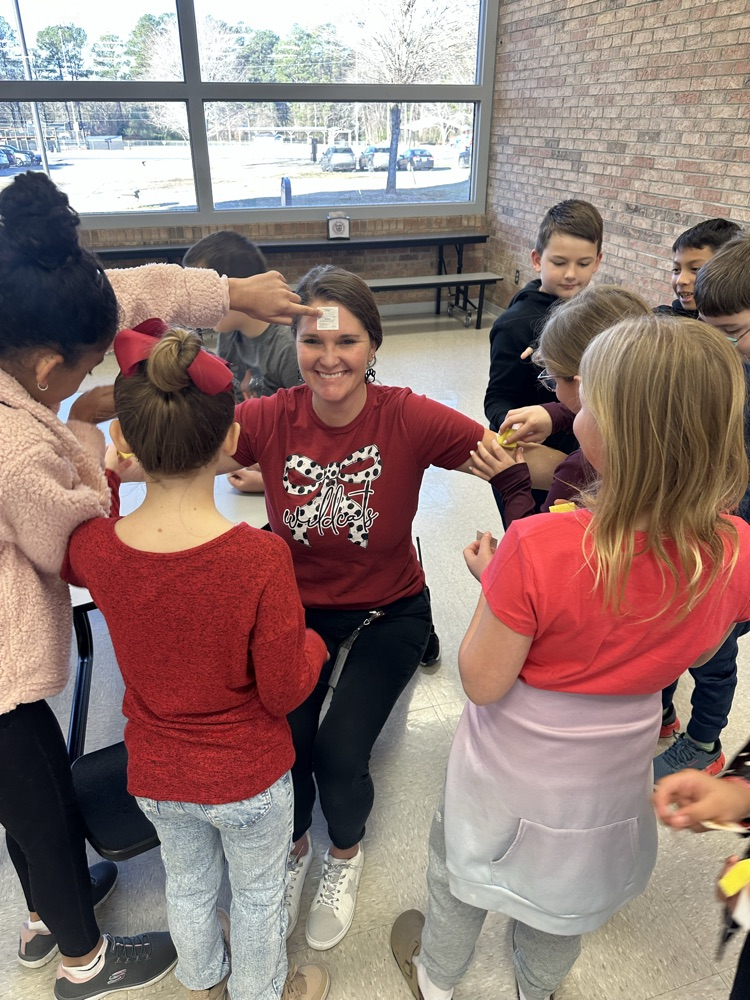 students apply temporary tattoos on administrators 