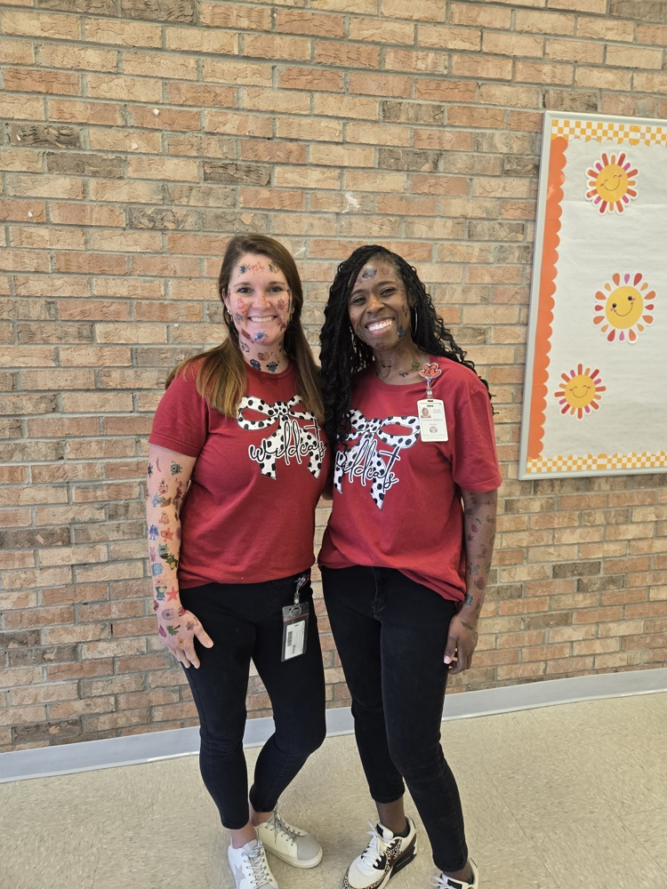 students apply temporary tattoos on administrators 