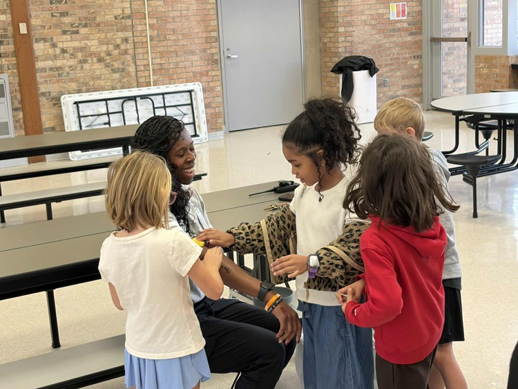 students apply temporary tattoos on administrators 