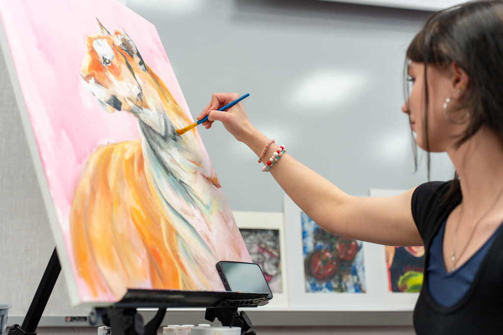 Students paint at Showcase of Schools.