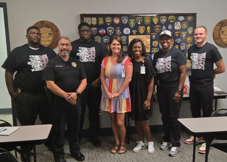 School resource officers, pictured with school administrators and chief of police