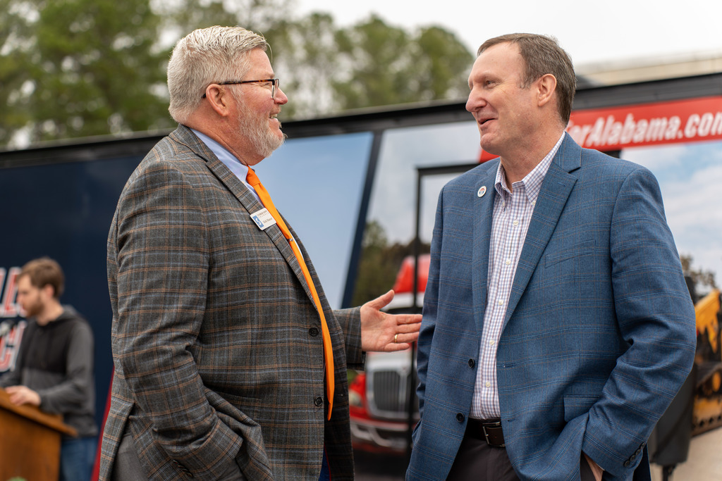 Individuals speak at the ceremony.