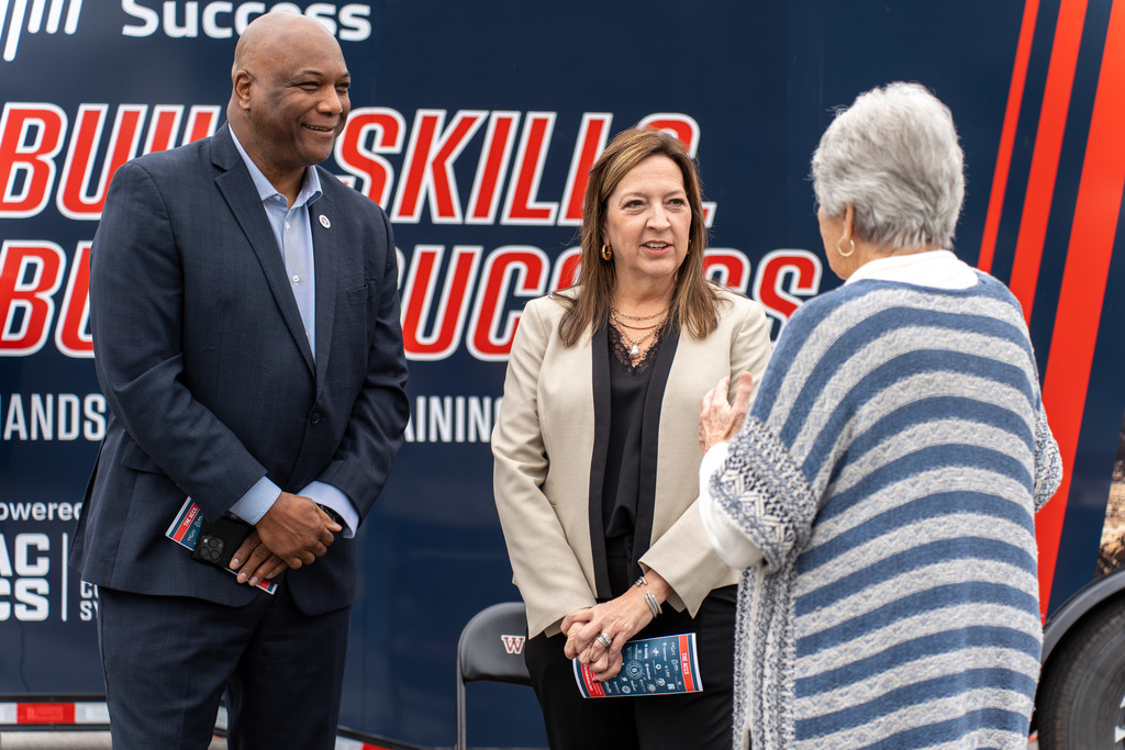 Individuals speak at the ceremony.
