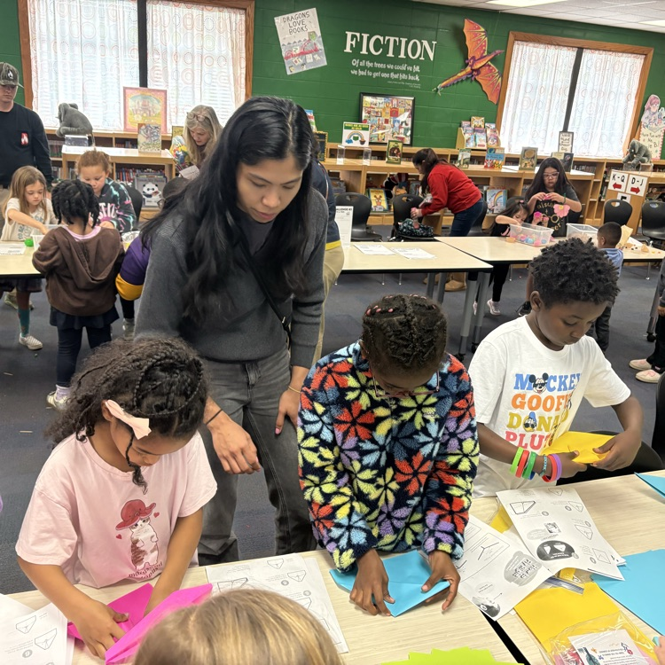 mom and children make paper airplanes 