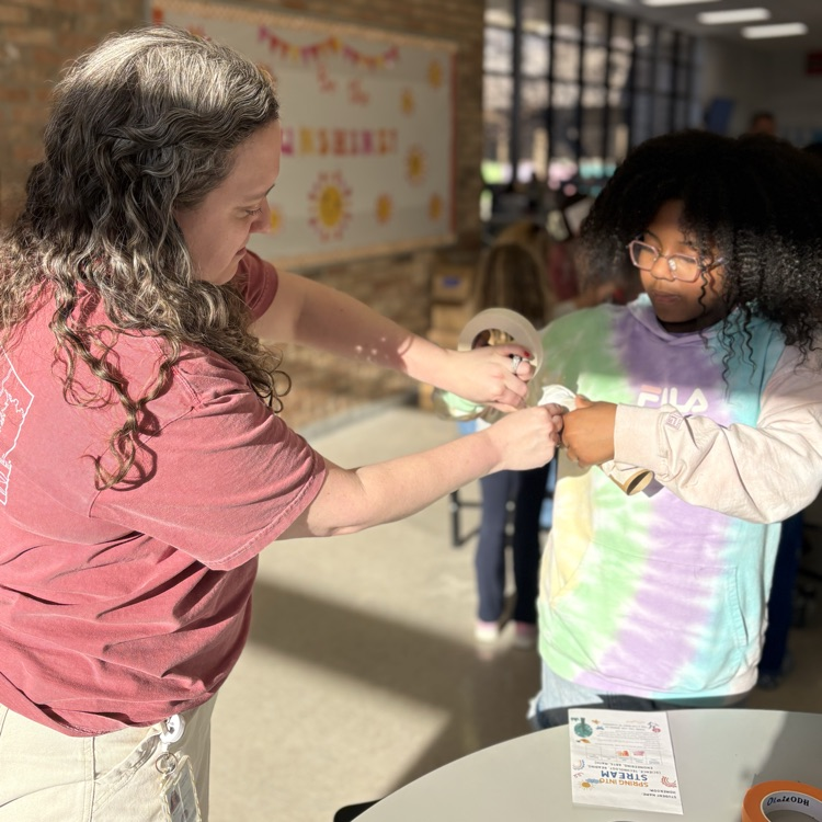 teacher helps student seal a handmade shaker
