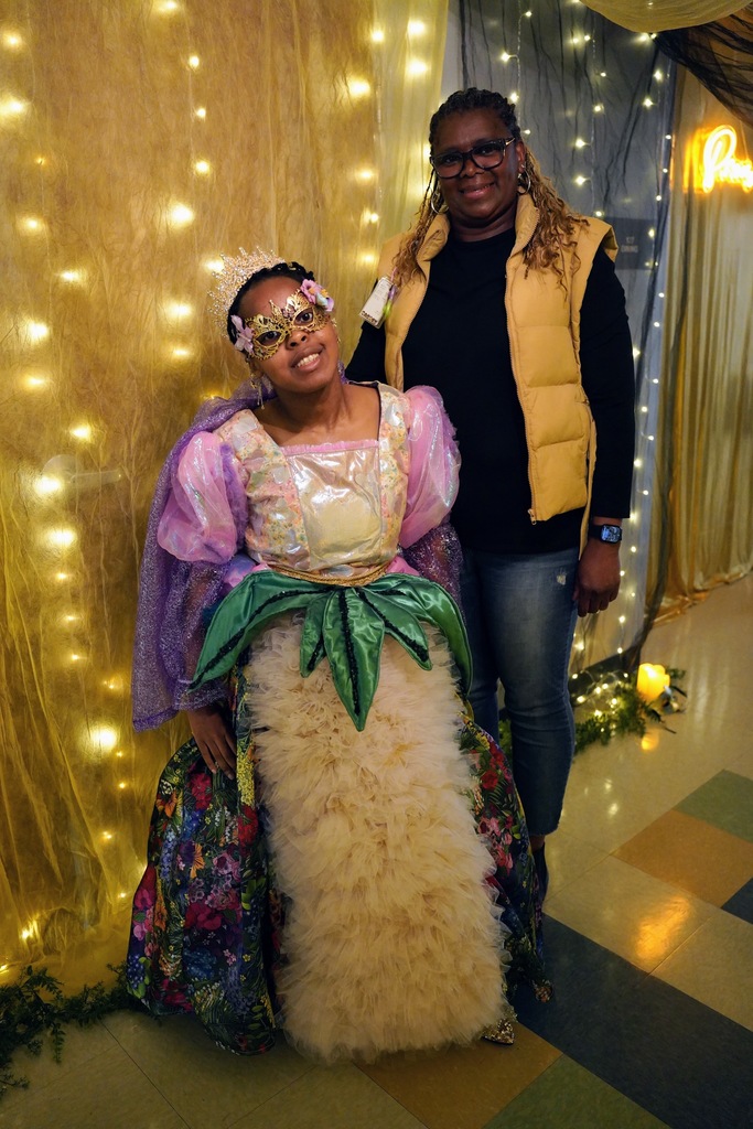 LNLC Student Holayn Marandu poses in her prom dress with Cynthia Parker