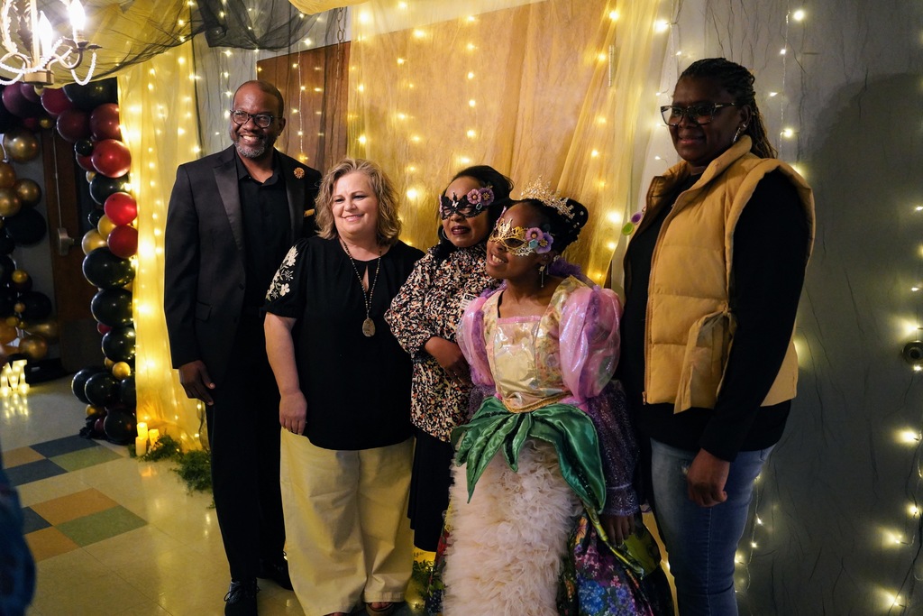 LNLC Student Holayn Marandu poses in her prom dress with principal, mom, paraprofessional and seamstress.