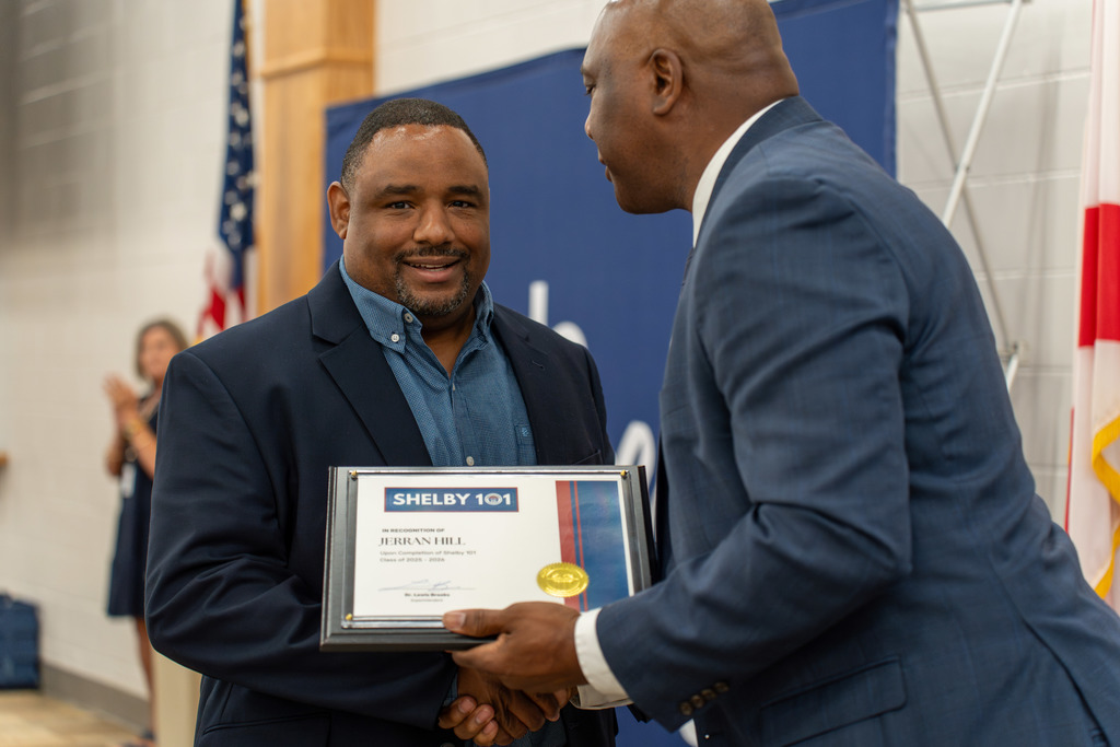 Jerran Hill receiving his certificate from Dr. Lewis Brooks 