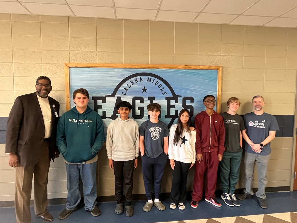 Students posing for a photo after winning first place in a competition at the University of Alabama