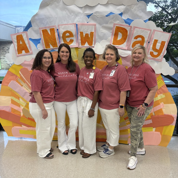 five ladies standing I front of a sunshine backdrop 