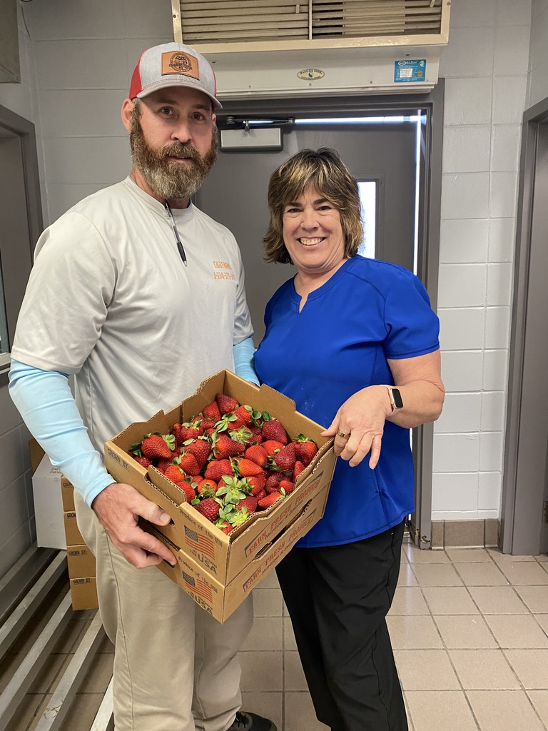 CNP Manager with fresh strawberries and produce supplier