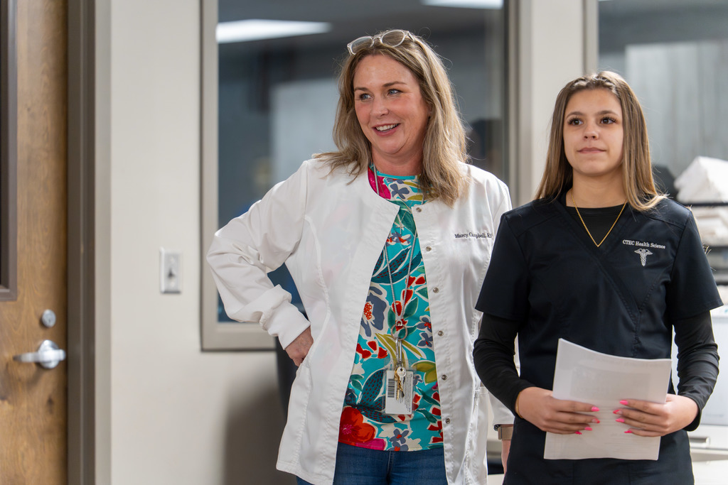 Health instructor with student in healthcare class 