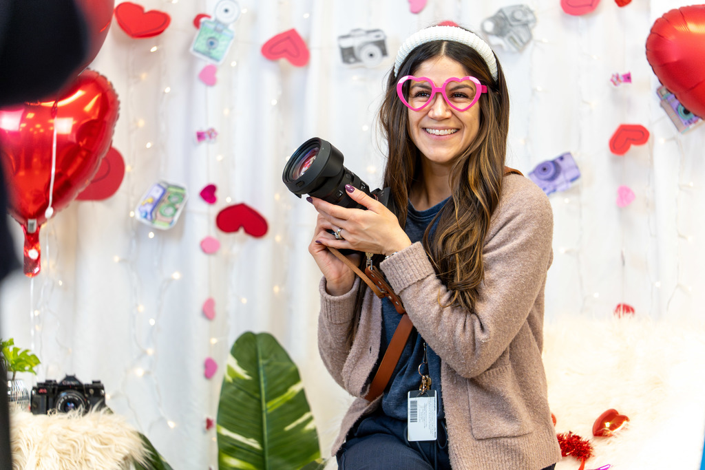 Teacher holding a camera at Showcase of Schools event 